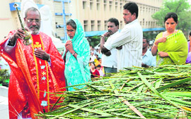 A priest blesses palm leaves by sprinkling holy water at a church in Secunderabad, Andhra Pradesh, on Sunday.