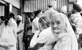 An old woman as also others wait for the arrival of the sub-registrar at his office in the Deputy Commissioner complex in Mohali on Monday.