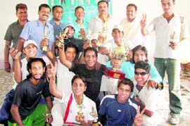 The team members of the Himalaya Cricket Academy pose with their trophies after winning the Uttarakhand and UP Real Host Cup cricket tournament in Biharigarh on Monday. A Tribune photograph