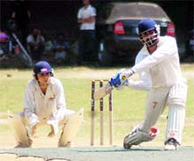 A batsman plays a shot during a match at the 3rd All-India Uttarakhand Cup Cricket tournament in Dehradun on Monday. A Tribune photograph