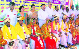 Newly wedded couples being blessed by prominent citizens after a mass-marriage ceremony at Divyank Garden in Sonepat.