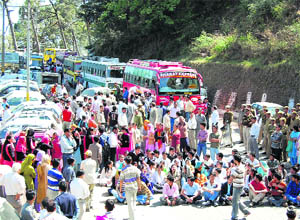 Students of B.Ed College hold traffic in protest against suicide of their teacher at Dhenda, 10 km from Shimla, on Monday.