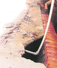 Due to the construction of wall of basement, the road of a street has become hollow, posing danger