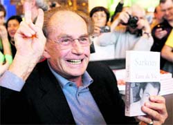 French President Nicolas Sarkozy's 82-year-old father Pal unveils his book "Tant De Vie"("So Much Life") at the book fair in Paris on Sunday. The book is an autobiography that describes his own active and turbulent love life and the president's childhood.  AP/PTI