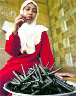 A villager eats "ampo", a traditional snack made from clean, gravel-free dark earth, in Tuban, East Java province, on Monday. Although there is no medical evidence, villagers believe the soil snacks are an effective painkiller and pregnant women are encouraged to eat them as it is believed to refine the skin of the unborn baby.  Reuters