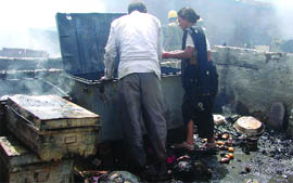 A couple look for their belongings after a slum cluster in Shalimar Bagh, New Delhi, caught fire on Tuesday.