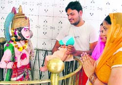 Devotees offer prayers at a Hanuman temple in Ludhiana on Tuesday. Photo: Inderjeet Verma
