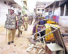 Security personnel patrol a street after a communal clash in Secunderabad on Tuesday