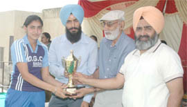 S. Rajpal Singh, captain of the national hockey team, honouring Amarjeet during the annual athletic meet on Wednesday.