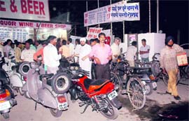 Rush at a liquor shop near the Mohali border in Sector 55, Chandigarh, on Wednesday evening. Tribune photo: Parvesh Chauhan