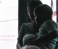 The girl in her mothers arms.