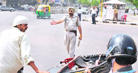 A cop clears the route for the DGPs cavalcade in Ludhiana on Wednesday.