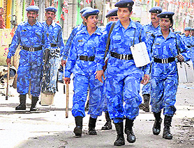RAF personnel patrol a street in the curfew-bound old Hyderabad city on Wednesday. Curfew has been imposed in the area in the view of sectarian clashes.