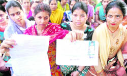 Students protest against confusion in timing of their exam outside the Government College for Girls in Patiala on Wednesday.