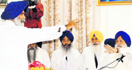 HSGPC president (ad hoc) Jagdish Singh Jhinda (standing) argues with SGPC president Avtar Singh during the committees budget session in Amritsar on Wednesday.