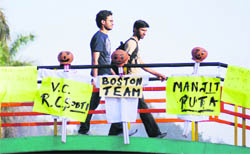 PU students walk past the posters that were pasted to play a prank on the VC at the Student Centre in Chandigarh 