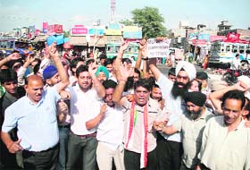 Activists of the Nirbhow Nirvair Organisation stage a protest against the Municipal Corporation in Jammu