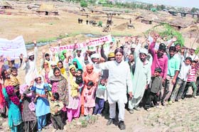 Gujjars hold a protest after being served notices for the removal of their shelters near the Tawi area of Belicharana in Jammu