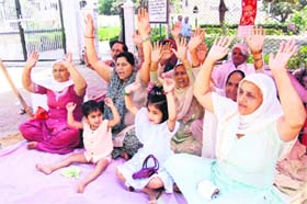 Members of the PoK Refugees Association protest in support of their demands in front of the Divisional Commissioners office in Jammu
