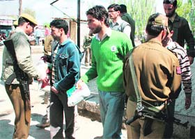 Policemen check the luggage of passengers at Lal Chowk in Srinagar