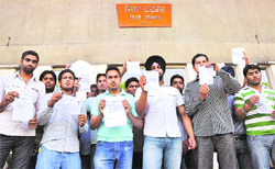 Students of GGN College protest outside the DC's office in Ludhiana on Thursday.