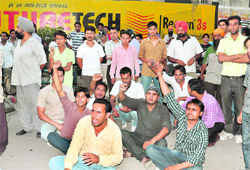 Boys stage a dharna outside a chemists shop.