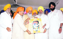 Punjab Tourism Minister Hira Singh Gabria, Sukhdev Singh Dhindsa, Punjab Transport Minister Master Mohan Lal and Bikramjit Singh Tohra release a calendar on Gurcharan Singh Tohra at Tohra village, near Patiala, on Saturday