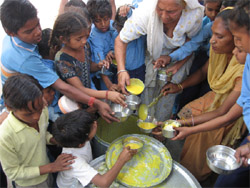 Students of the school struggle to get their mid-day meal.