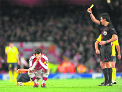 Arsenal captain Cesc Fabregas reacts after being shown a yellow card on Wednesday.
