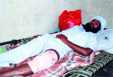 Malkeet Singh, who was shot at on his leg by assailants, lies on a cot in Guru Nanak Dev Hospital in Amritsar. Photo: Vishal Kumar