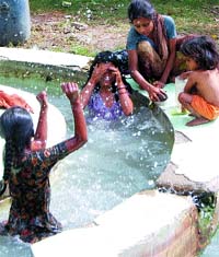 Children enjoy a bath in fountain water in Gol Bagh in Amritsar. Photo: Vishal Kumar