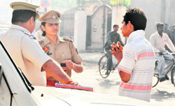 A traffic violator seeks apology from SHO (traffic) Gurpreet Kaur in Ludhiana on Friday