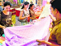 Visitors check out clothes at the exhibition