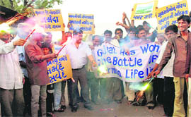 People celebrate the Supreme Court verdict to allow the increase in the height of Narmada Dam to 138.52 metres, in Ahmedabad on Friday. 
