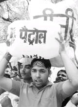 Activists of Bhartiya Janta Yuva Morcha and Kisan Morcha hold diesel and petrol cans and shout anti-UPA slogans in front of Commonwealth Games office, during a demonstration against price rise in New Delhi. Tribune photo: Manas Ranjan Bhui
