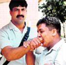 One of the official of Pakistan Kabaddi team offering cigarette to a player at Attari-Wagah joint check post on Friday. Tribune photo: Vishal Kumar