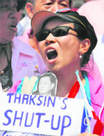 cry of support: An office worker holds a sign during a gathering outside a park to show support for the government and voice her opposition to the anti-government rally in Bangkok on Friday.