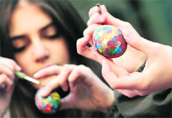 celebrations galore: Children paint eggs for Easter in Tbilisi, Georgia, on Friday. Georgian Orthodox believers will celebrate Easter on April 4.