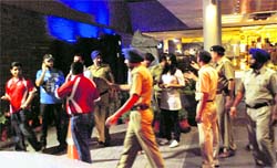 Visitors to Hotel Mountview are denied entry by policemen in Chandigarh on Friday night. Tribune photo: Vicky Gharu