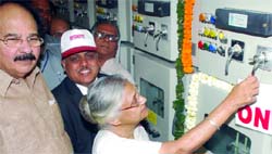 Chief Minister Sheila Dikshit dedicates a 66/11KV grid for Commonwealth Games as Delhi finance minister A.K. Walia looks on, in New Delhi on Saturday. Tribune photo
