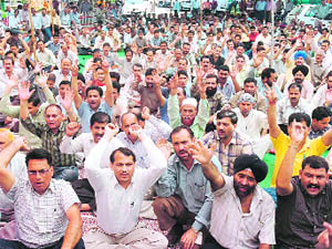Paramedical staff hold a protest at the SMGS Hospital at Shalamar in Jammu on Saturday. 