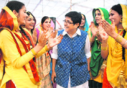 Former IPS officer Kiran Bedi interacts with the girls performing Giddha during her visit at Chandigarh Group of Colleges, Landra, in Mohali on Saturday. 