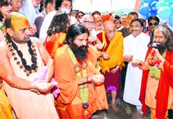 Tibetan spiritual leader Dalia Lama, former Deputy Prime Minister LK Advani, yoga guru Ramdev with Uttarakhand Chief Minister Ramesh Pokhriyal Nishank take a pledge to clean the Ganga at the launch of the Sparsh Ganga campaign in Rishikesh on Sunday. 