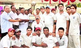 The Ajabpur Youngstars team with the 3rd All-India Uttarakhand Cup trophy in Dehradun on Sunday. A Tribune photograph