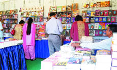 Customers browse books at a stall of the book fair, organised by the National Book Trust, in Amritsar.