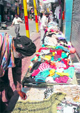Locals purchase clothes from roadside stalls in the Sunday Market in Jammu.