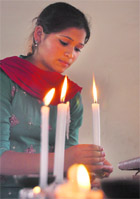A girl lights a candle to celebrate Easter Sunday in Ludhiana.