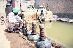 Rajinderpal Singh supervises the production of rose oil in his house in Kalalwala village of Bathinda district.