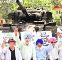  People hold a protest at the War Memorial in Patiala on Sunday. 