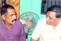 Local Bodies Minister Manoranjan Kalia with Sachins father at the family home in Malhan village on Sunday. 